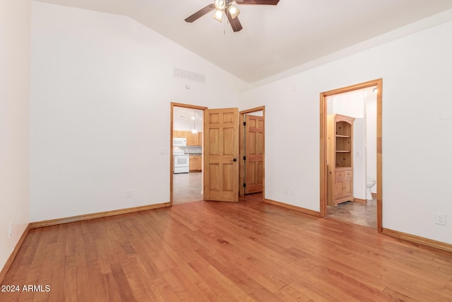 unfurnished bedroom with ensuite bathroom, light hardwood / wood-style flooring, ceiling fan, and high vaulted ceiling