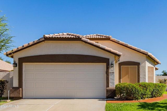 mediterranean / spanish-style home with a garage