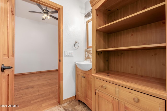 bathroom featuring ceiling fan, vanity, and wood-type flooring