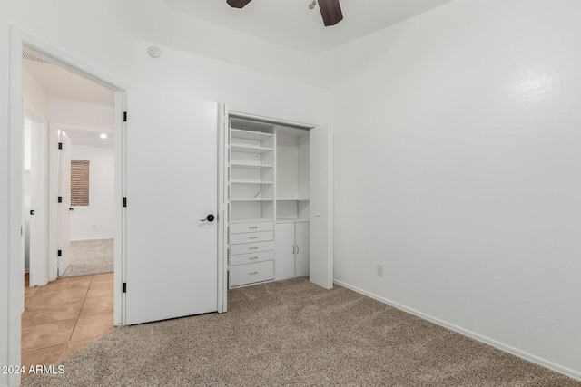 unfurnished bedroom with ceiling fan, a closet, and light colored carpet