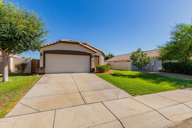 view of front of house with a garage and a front lawn