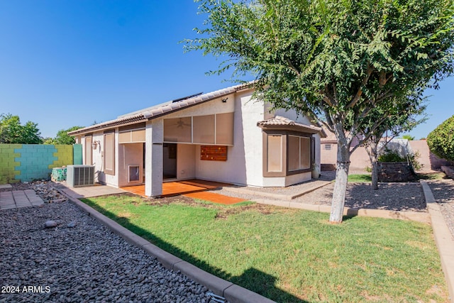 rear view of house with a patio and cooling unit