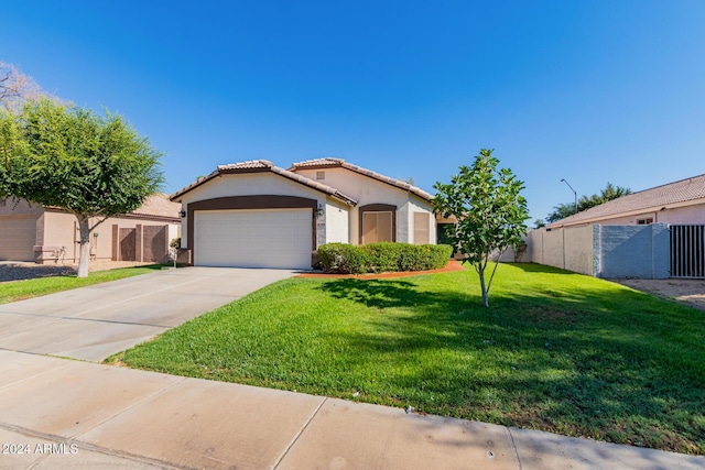 view of front of property featuring a front yard and a garage