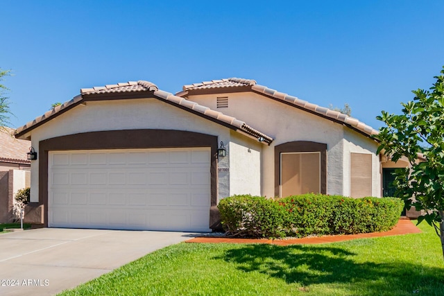 mediterranean / spanish-style home with a garage