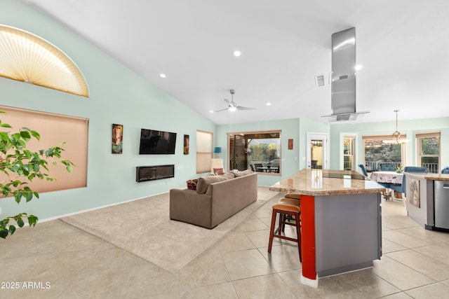 kitchen with range hood, pendant lighting, a breakfast bar area, open floor plan, and a kitchen island