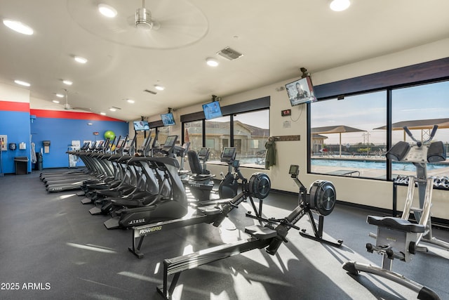 exercise room with recessed lighting, visible vents, vaulted ceiling, and baseboards