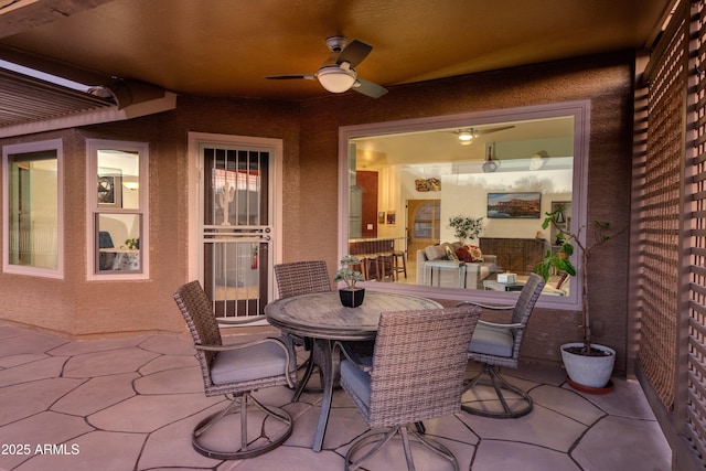 view of patio with ceiling fan and outdoor dining area