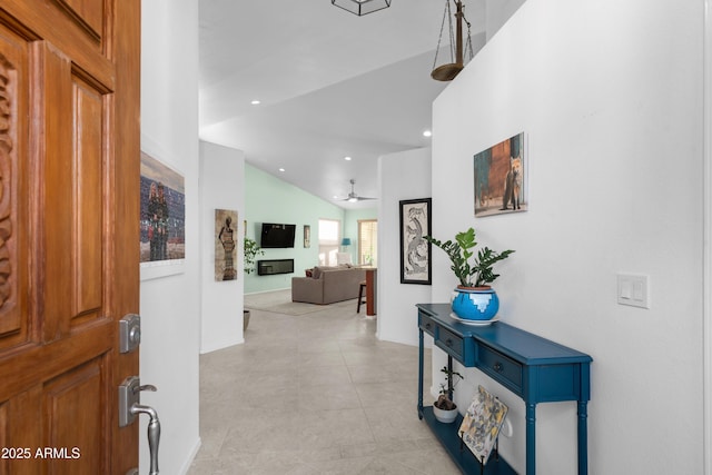 entryway featuring vaulted ceiling, ceiling fan, a fireplace, and recessed lighting