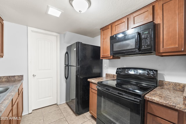 8125 N 32nd Dr, Phoenix, AZ 85051 - kitchen featuring black appliances, brown cabinets, and light tile patterned floors