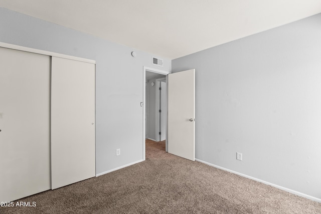 8125 N 32nd Dr, Phoenix, AZ 85051 - unfurnished bedroom featuring carpet flooring, a closet, and baseboards