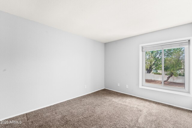 8125 N 32nd Dr, Phoenix, AZ 85051 - empty room featuring carpet flooring and baseboards