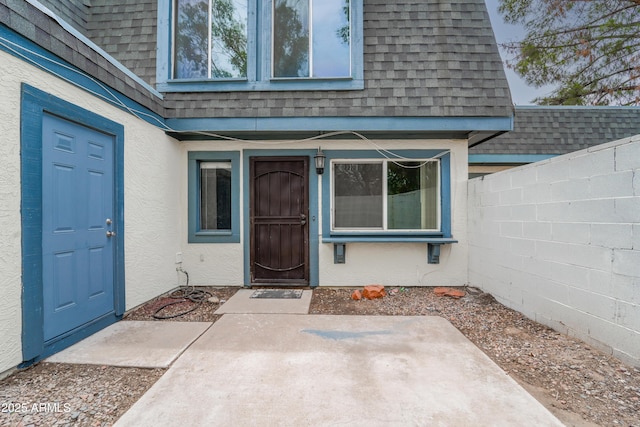 8125 N 32nd Dr, Phoenix, AZ 85051 - property entrance featuring a shingled roof, stucco siding, and a patio area