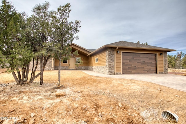 5974 E Elk Spgs, Lakeside, AZ 85929 - view of front of home with stone siding, driveway, and a garage