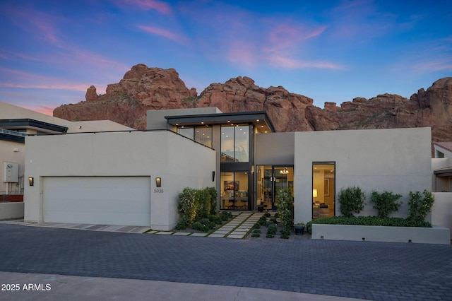 5935 N Echo Canyon Ln, Phoenix, AZ 85018 - contemporary home with an attached garage, decorative driveway, and stucco siding