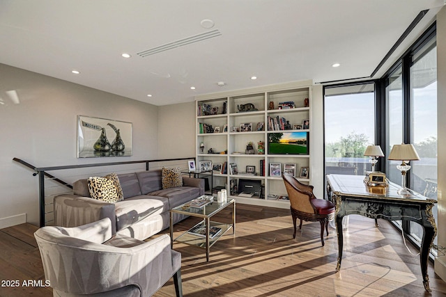 interior space featuring visible vents, a wall of windows, wood finished floors, and recessed lighting