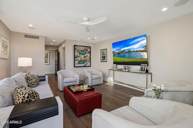 living room with recessed lighting, visible vents, and wood finished floors