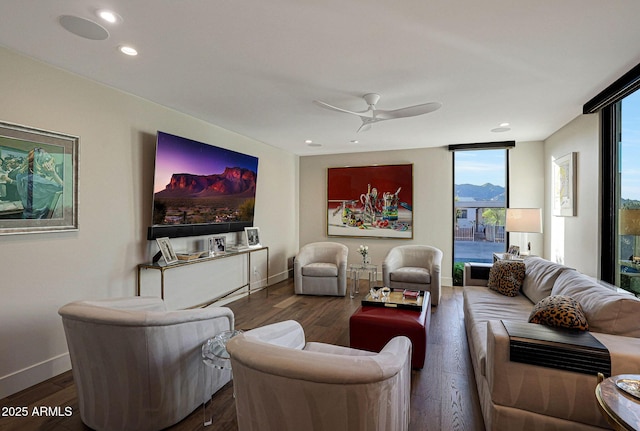 living area featuring expansive windows, baseboards, dark wood-type flooring, and recessed lighting