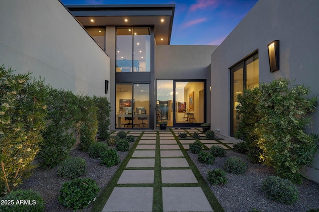 back of house featuring stucco siding