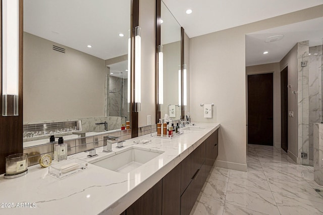 bathroom featuring marble finish floor, visible vents, a sink, and a marble finish shower