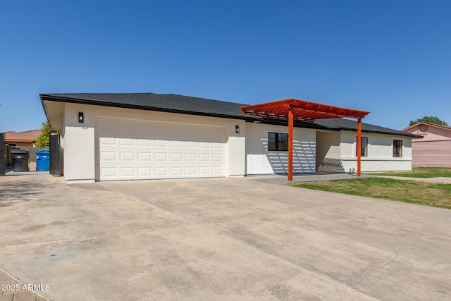 view of front of property with stucco siding, driveway, and an attached garage