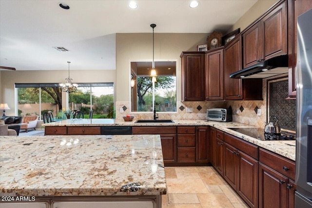 kitchen featuring light stone counters, black appliances, sink, and plenty of natural light