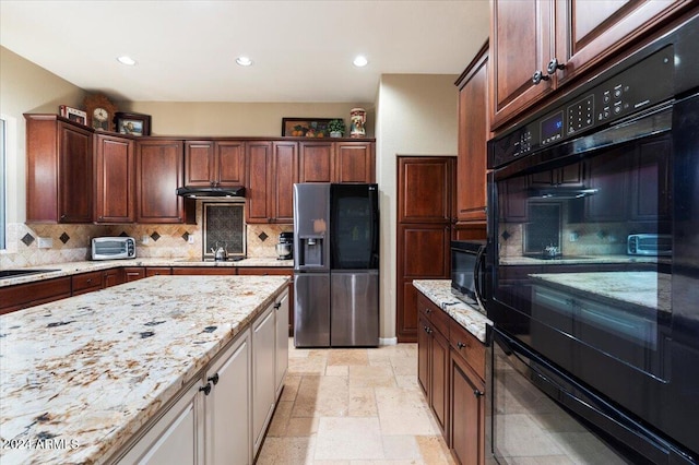 kitchen featuring light stone countertops, black appliances, and backsplash