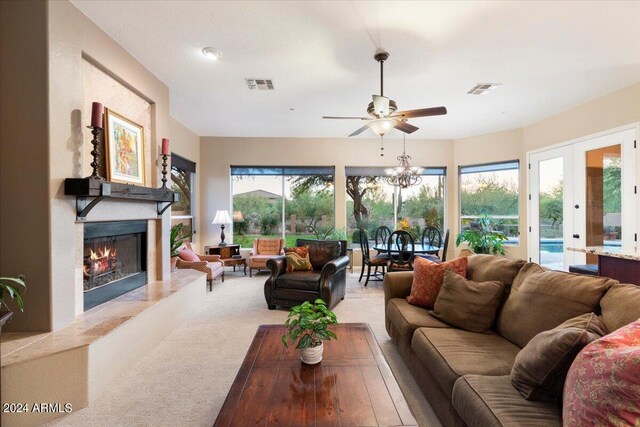 carpeted living room with french doors, ceiling fan, and a wealth of natural light