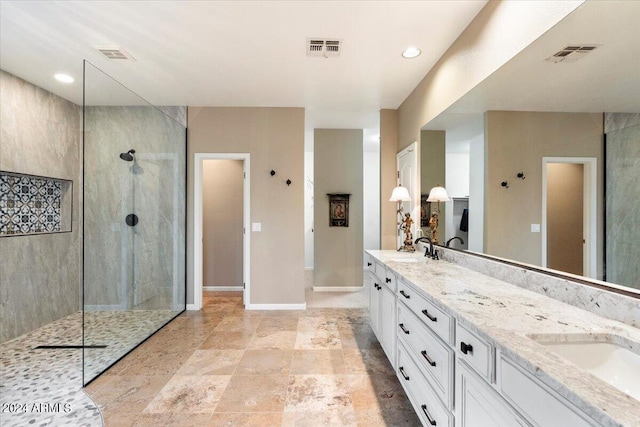 bathroom with vanity and tiled shower