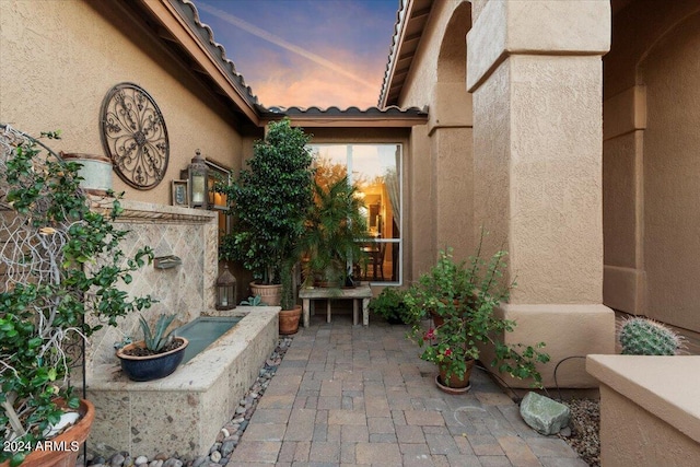 view of patio terrace at dusk