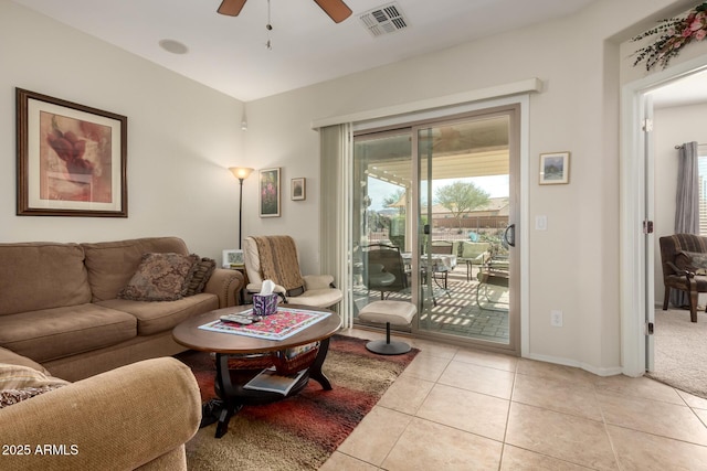 living area with visible vents, ceiling fan, baseboards, and light tile patterned floors