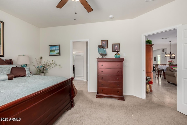 bedroom with light carpet, a notable chandelier, and light tile patterned floors