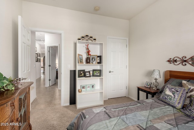 bedroom with light carpet and baseboards