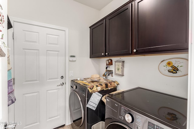 washroom with washer and clothes dryer and cabinet space