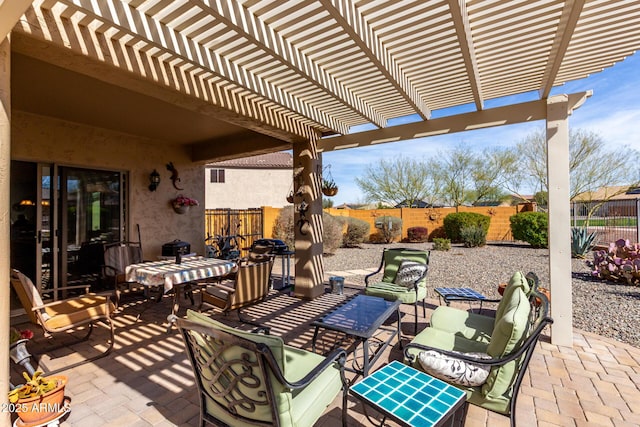 view of patio / terrace featuring a fenced backyard, an outdoor living space, and a pergola