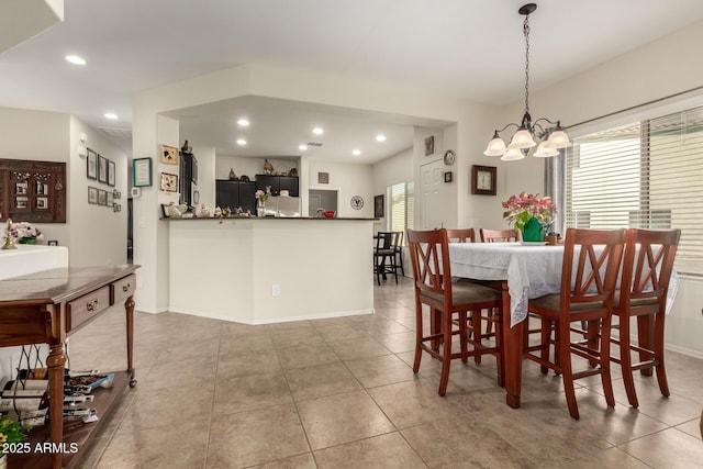 dining area with light tile patterned floors, baseboards, a chandelier, and recessed lighting