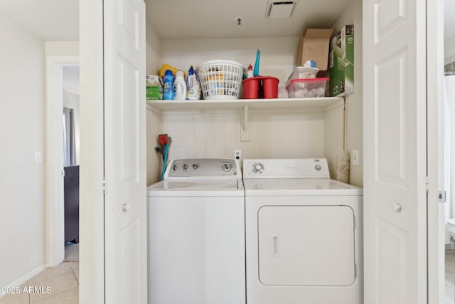 9450 E Becker Ln Unit 2067, Scottsdale, AZ 85260 - laundry area featuring washer and clothes dryer and light tile patterned floors