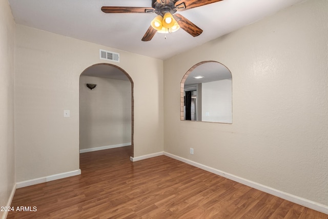 spare room with hardwood / wood-style flooring and ceiling fan