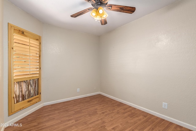 empty room featuring ceiling fan and hardwood / wood-style floors