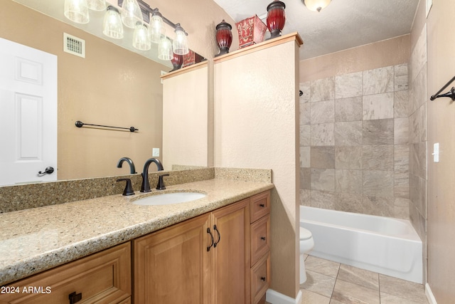 full bathroom with tile patterned flooring, vanity, toilet, and tiled shower / bath