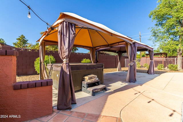 view of patio / terrace with a gazebo and a hot tub