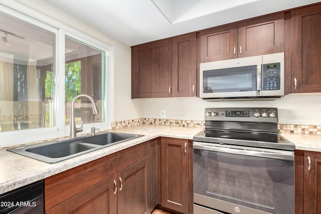 kitchen with sink and appliances with stainless steel finishes