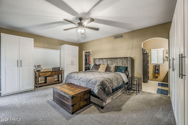 carpeted bedroom with ceiling fan