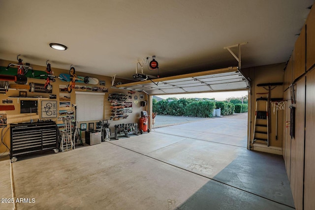 garage featuring a garage door opener and a workshop area