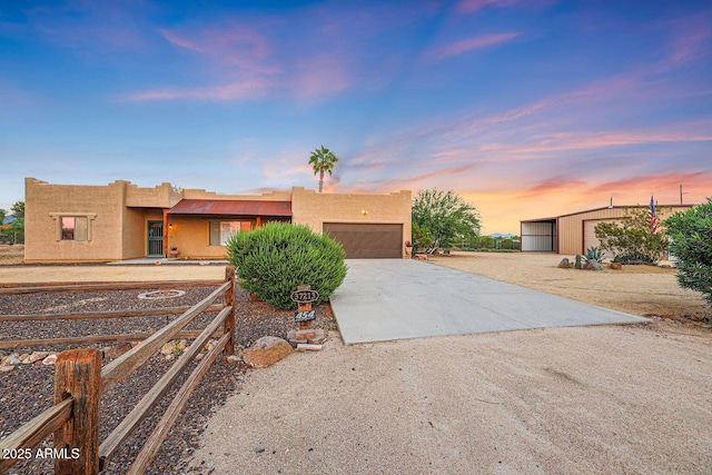 pueblo-style home featuring a garage