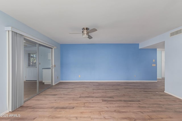 spare room featuring light wood-type flooring and ceiling fan