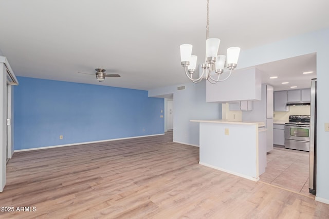 kitchen with decorative light fixtures, light wood-type flooring, ceiling fan with notable chandelier, stainless steel range with electric stovetop, and gray cabinetry