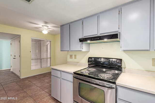 kitchen with ceiling fan, stainless steel range with electric cooktop, and light tile patterned floors