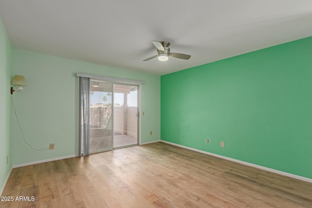 spare room with ceiling fan and light wood-type flooring