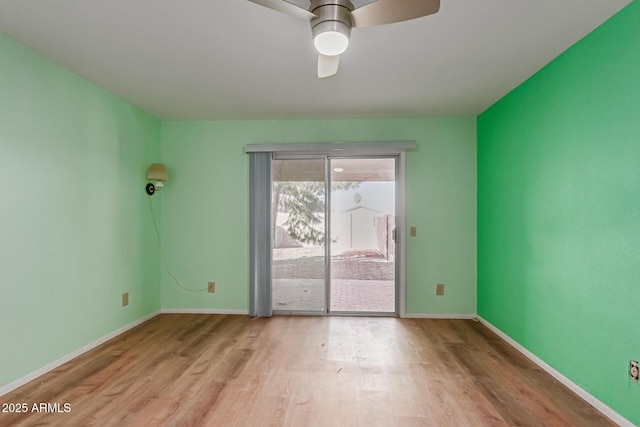 spare room with ceiling fan and light wood-type flooring