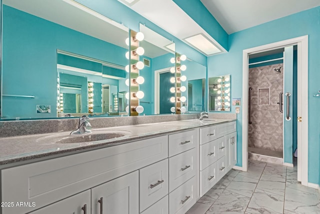 bathroom featuring walk in shower and vanity